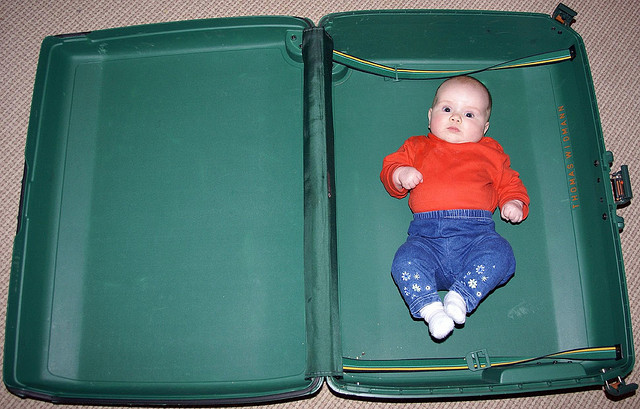 baby in open suitcase