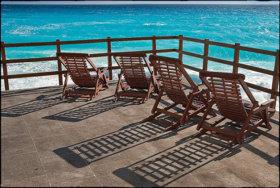 deck chairs on beach via flickr by mike mcholm