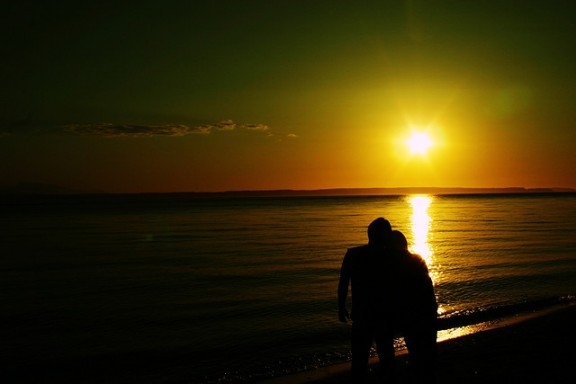 Couple on beach by LaserGuided via Flickr