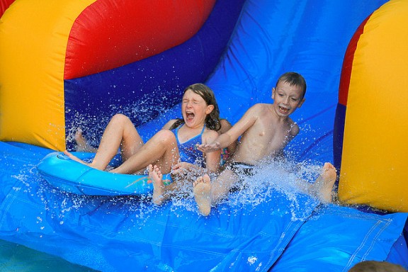 Kids on water slide by Steve Alexander via Flickr